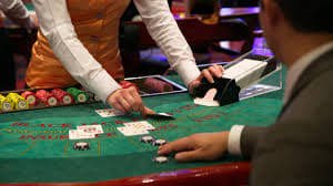 Live Super Sic Bo table with croupier rolling three dice on broadcast